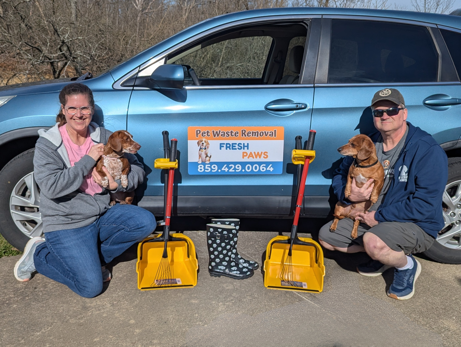 Alan and Taryn with their dachshunds Bruno and Daisy in front of the Fresh Paws service vehicle