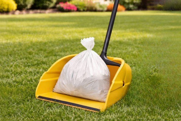 Fresh Paws technician cleaning up pet waste